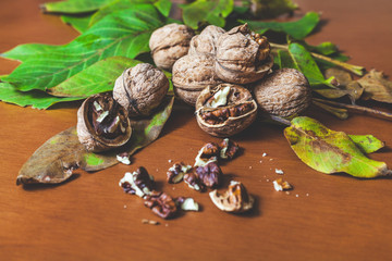 Several walnut kernels and lie on  brown background