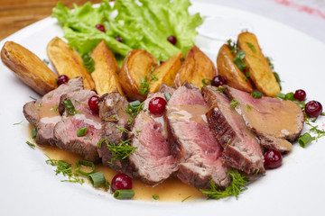 Tasty roasted pork meat with potatoes