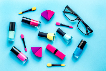 concept cosmetic set on blue background top view