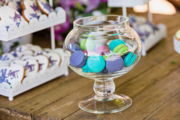 Macaroons colorful in vase on wooden table