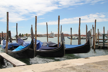 Obraz na płótnie Canvas Venetian landscape with gondolas and mooring piles.