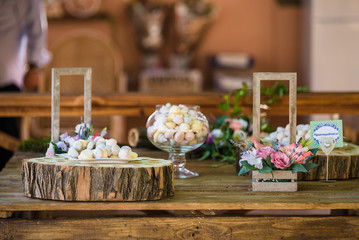 Delicious candy bar Dessert table for outdoor party. Ombre cake, cupcakes, sweetness, berries and flowers