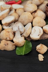 Fresh mushrooms for cooking on wood background.