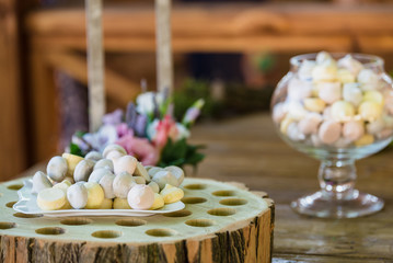 Delicious candy bar Dessert table for outdoor party. Ombre cake, cupcakes, sweetness, berries and flowers