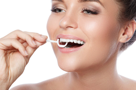 Woman and dental floss pick