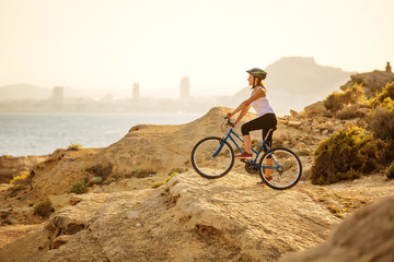 Fototapeta na wymiar woman on vacation biking at beach
