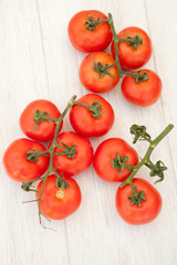 Picture of vine tomatoes on a white wooden background