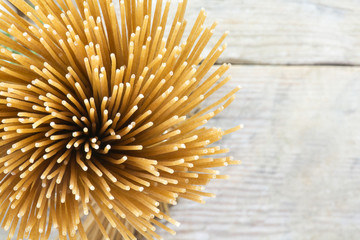 bunch of wholegrain spaghetti from above on a blurry background