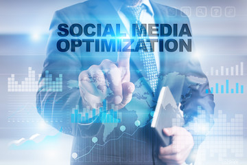 Businessman is pressing button on touch screen interface and selecting "Social media optimization".