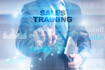 Businessman is pressing button on touch screen interface and selecting "Sales training".