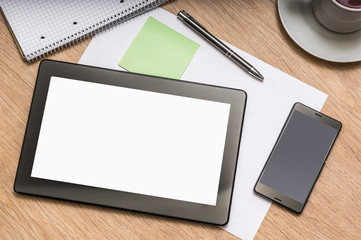 Digital tablet on business table with blank white screen