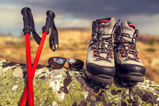 travel outdoor equipment - hiking boots, trekking poles, and sun