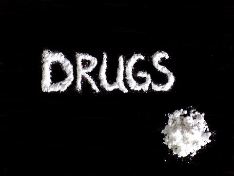 Cocaine Drug Powder In Shaped Word Drugs And Cocaine Pile On Black Background