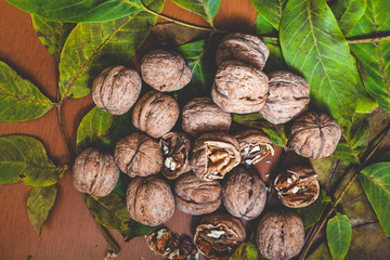 Several walnuts lie on brown background