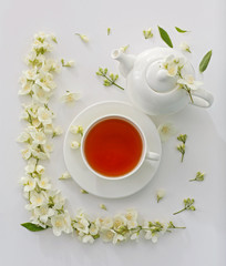 Obraz na płótnie Canvas Cup of tea with jasmine flowers on white background