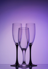 Silhouette champagne glasses on purple background