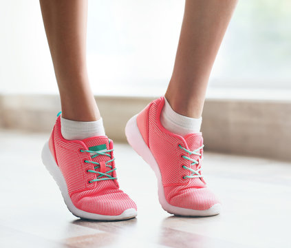 Woman wearing pink sneakers on blurred background © Africa Studio