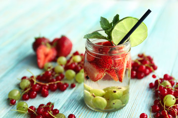 Refreshing water with fruits on table
