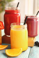 Refreshing fruit smoothie on table