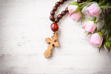 Wooden cross with flowers closeup