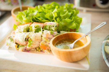 Fresh Vegetable Rice Wraps in dish with oils dip ready for sure (selective focus)