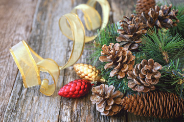 Pine cones and New-Year tree decorations on a wooden background