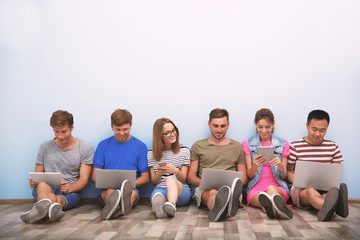 Young people with gadgets hanging out together