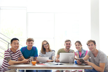 Young people with gadgets hanging out together