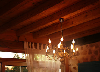 Decorative lamp hanging from wooden ceiling