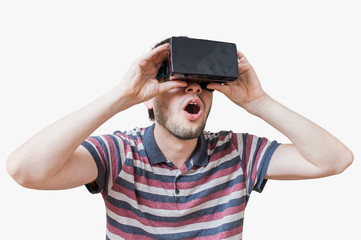 Man is wearing 3D virtual reality headset and is fascinated. Isolated on white background.