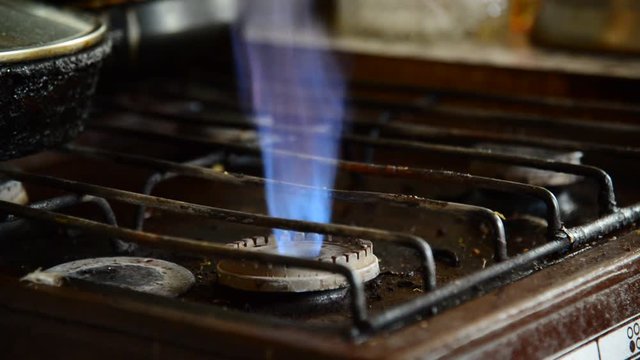 Flames from a gas burner on old kitchen stove