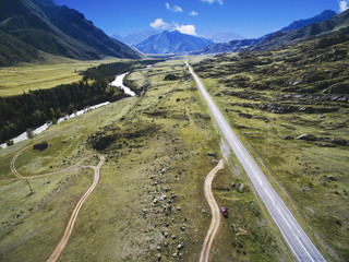 straight road in the valley of a mountain river