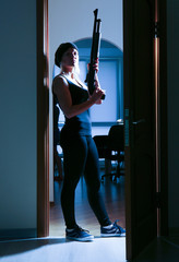 Armed thief entering a house