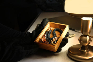 Thief stealing jewellery