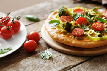 Tasty vegetarian pizza on wooden table