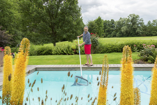 Man cleaning swimming pool