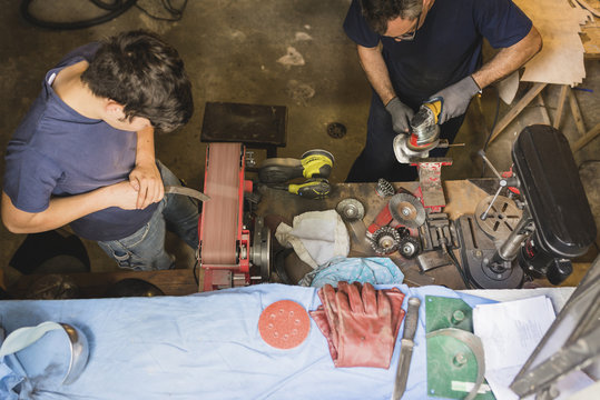 Two forgers working in workshop