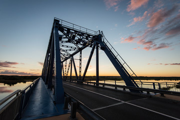 Fototapeta na wymiar railway bridge with metal rails near river