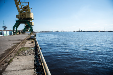 Fototapeta premium old crane with rusty metal rails near sea port