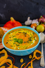Cream of pumpkin soup with pumpkin seeds, white cream, vegetable.