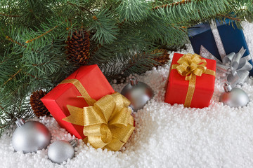 Gift boxes with Christmas balls in snow