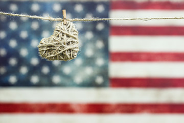 Heart hanging by rustic American flag