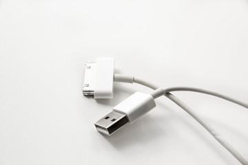 White wire usb mobile charging cable. 2 different cellphone charging plugs adapter from USB isolated on white background