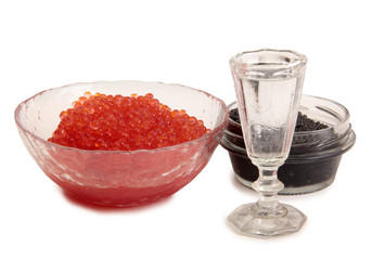 Fish caviar and glass of vodka on a white background