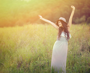 Girl enjoying nature on the field on a beautiful summer day