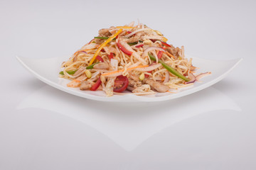 salad in a white plate on a white background