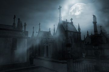 Cemetery in a foggy full moon night