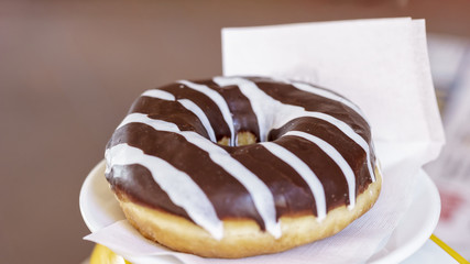 donut glazed with dark chocolate and white