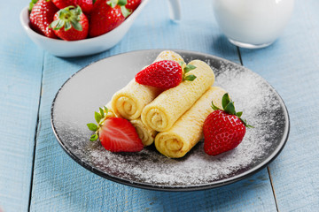 rolled pancakes with strawberries breakfast