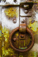 Rusty corroded details on painted steel door